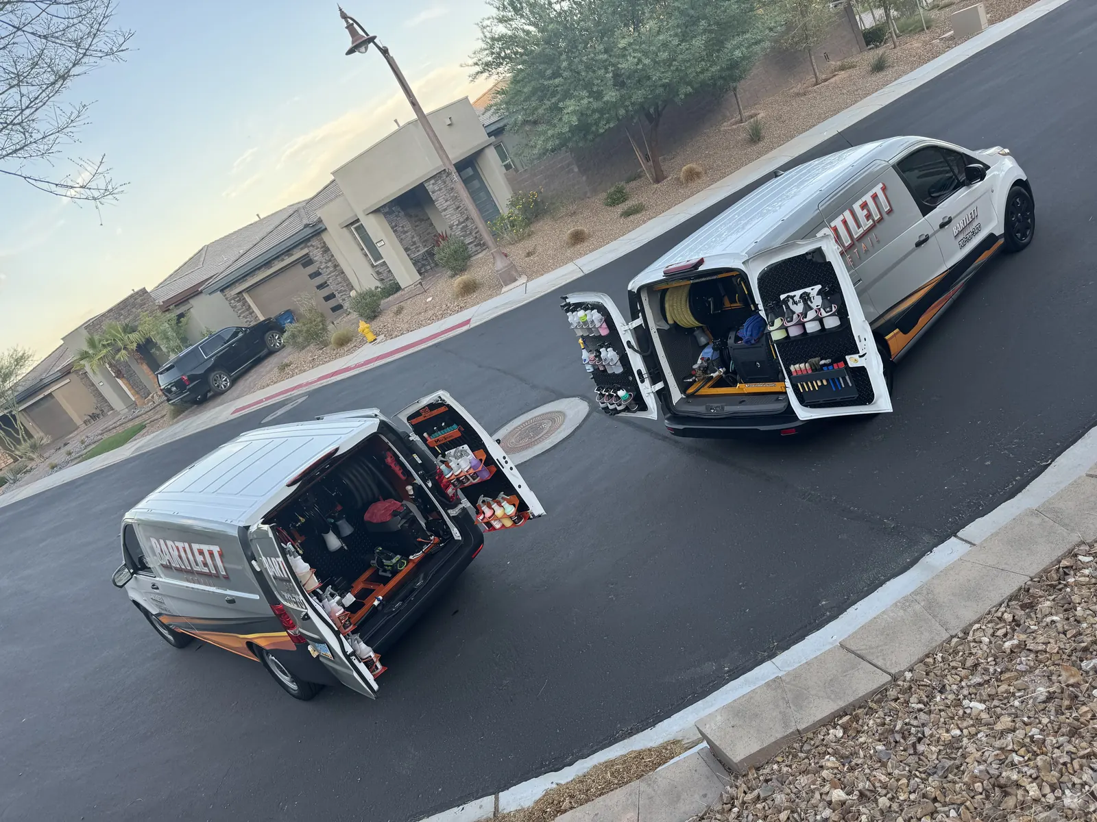 Two Bartlett vans with doors open and equipment ready