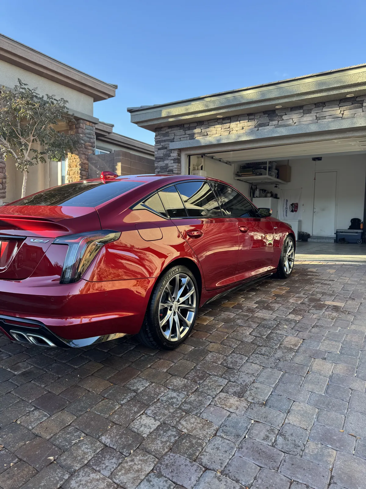 Red Cadillac detailed in a driveway